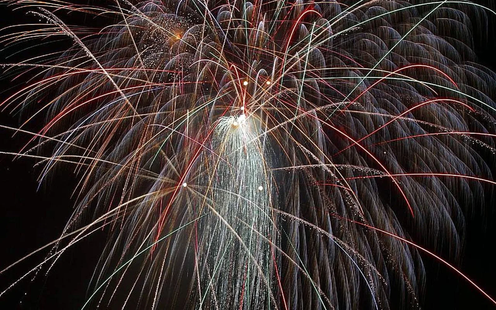 Colorful celebration fireworks at night against dark sky